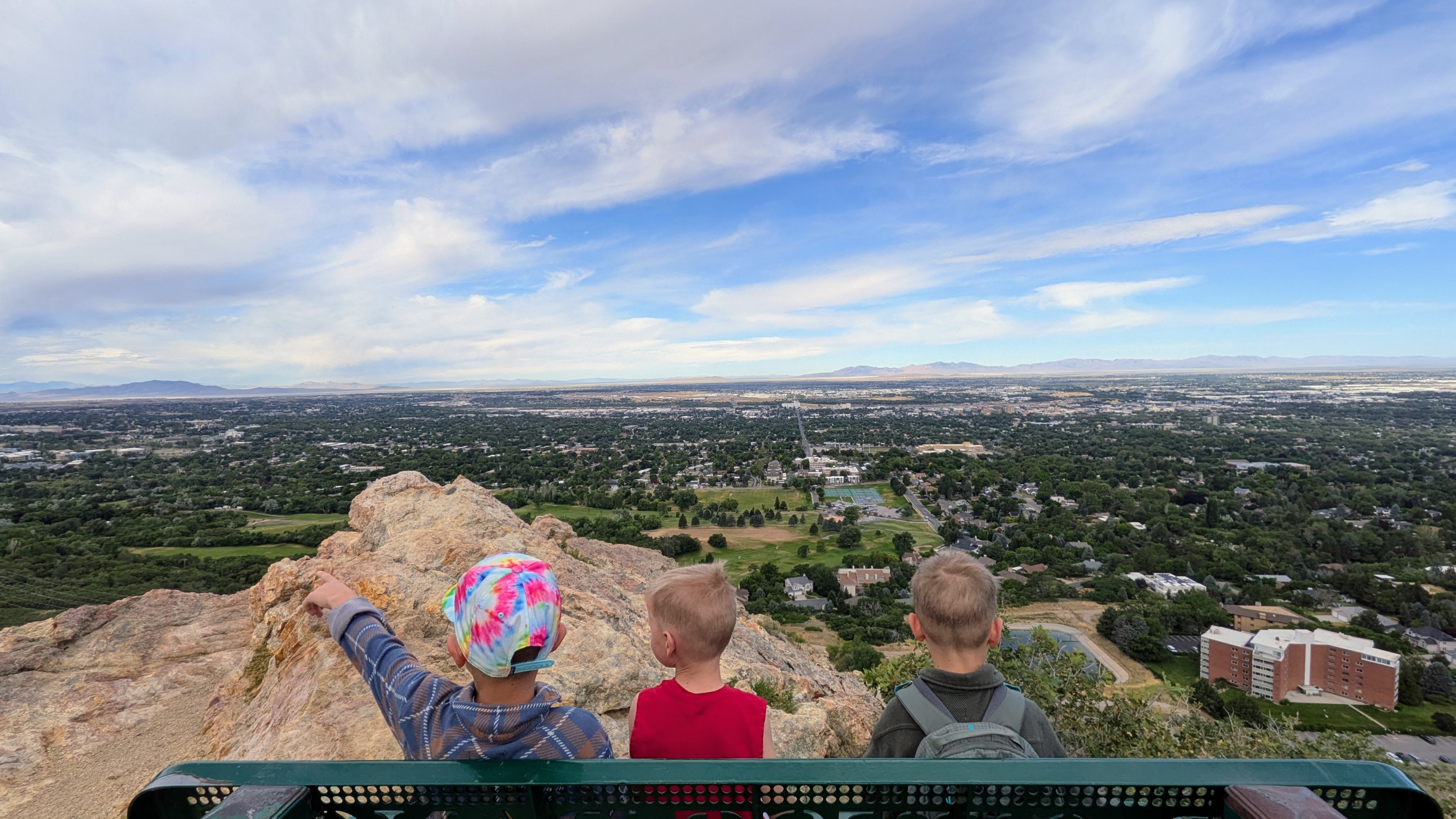 Three kids looking out over the Ogden valley from the Waterfall Canyon Pond Loop overlook